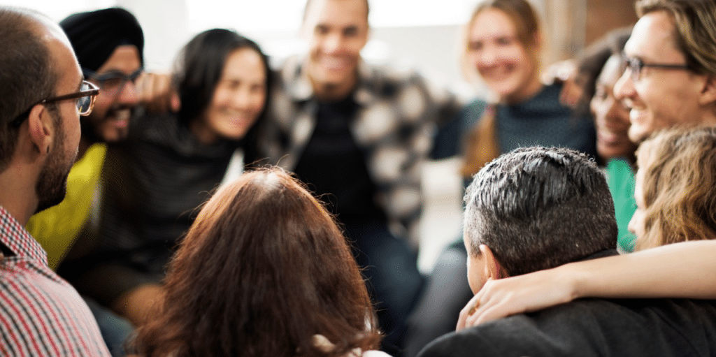 Diverse group embracing in a circle.